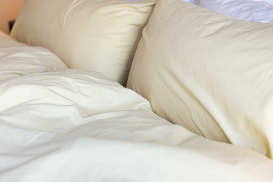 Close-up of bedding with pillows on a bed.