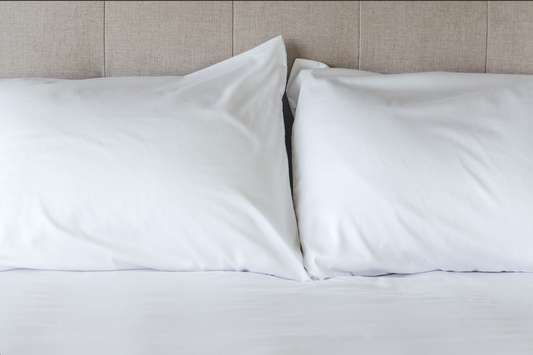 Bed showcasing pillowcases and split sheet