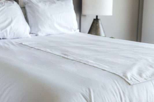 Split flat sheet on bed