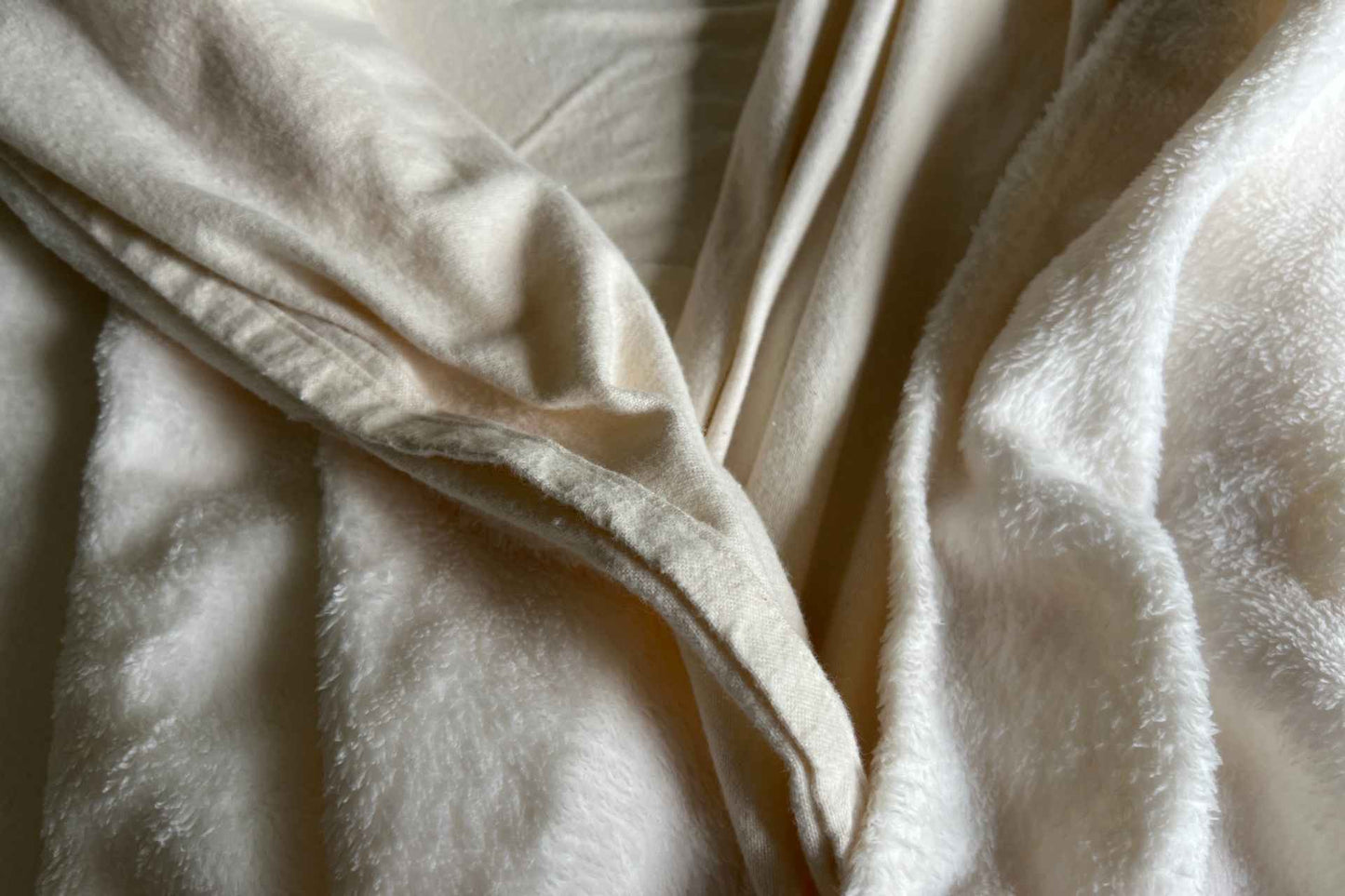 Close-up of flannel split flat sheet and minky fleece split blanket