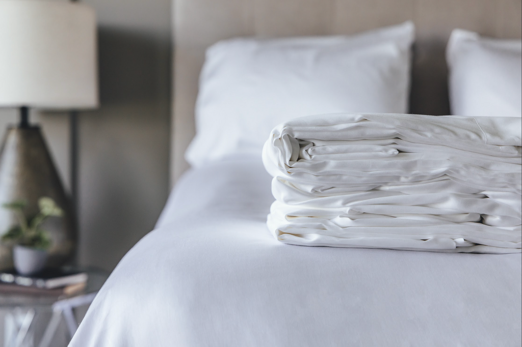 Bedroom showcasing folded sheet set