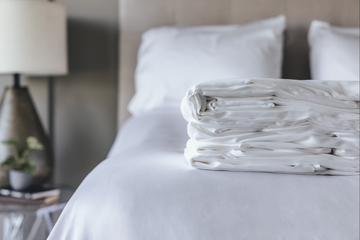 Bedroom showcasing folded sheet set
