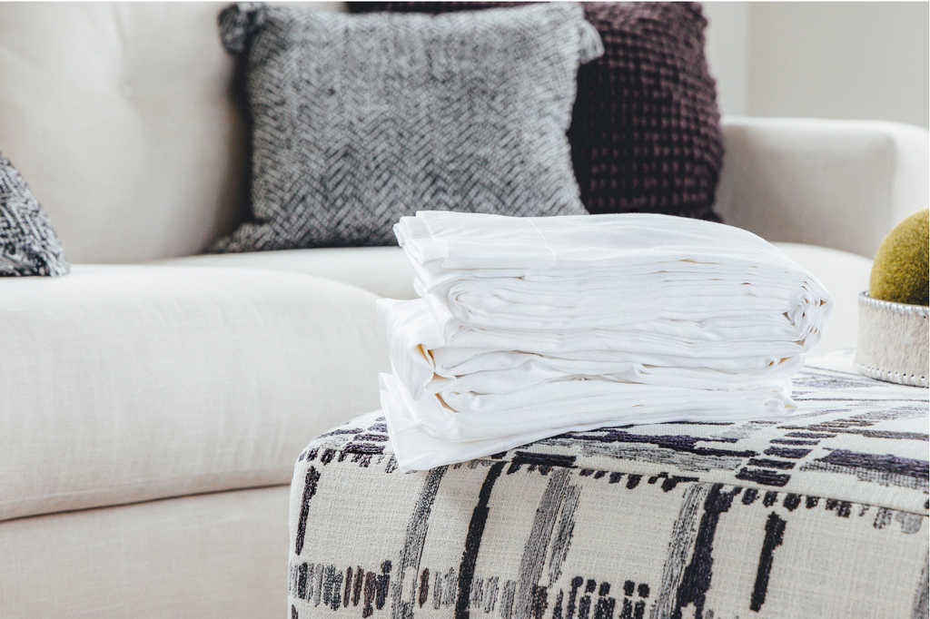 Folded sheets on ottoman 