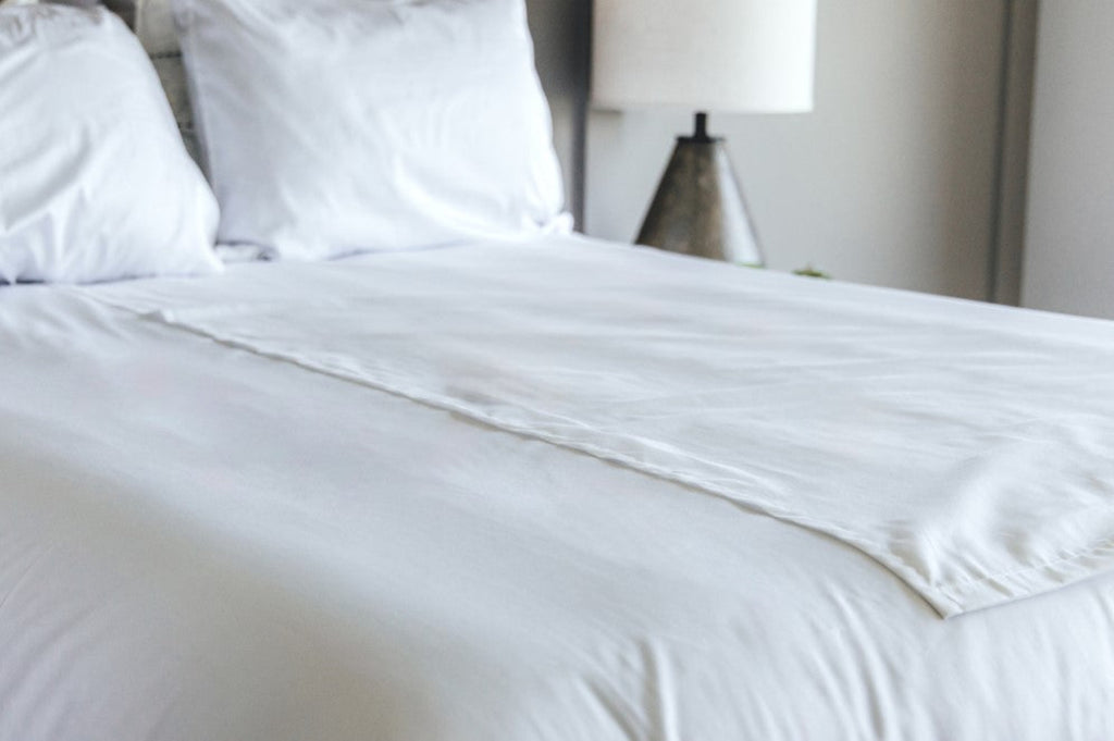 Split flat sheet on bed