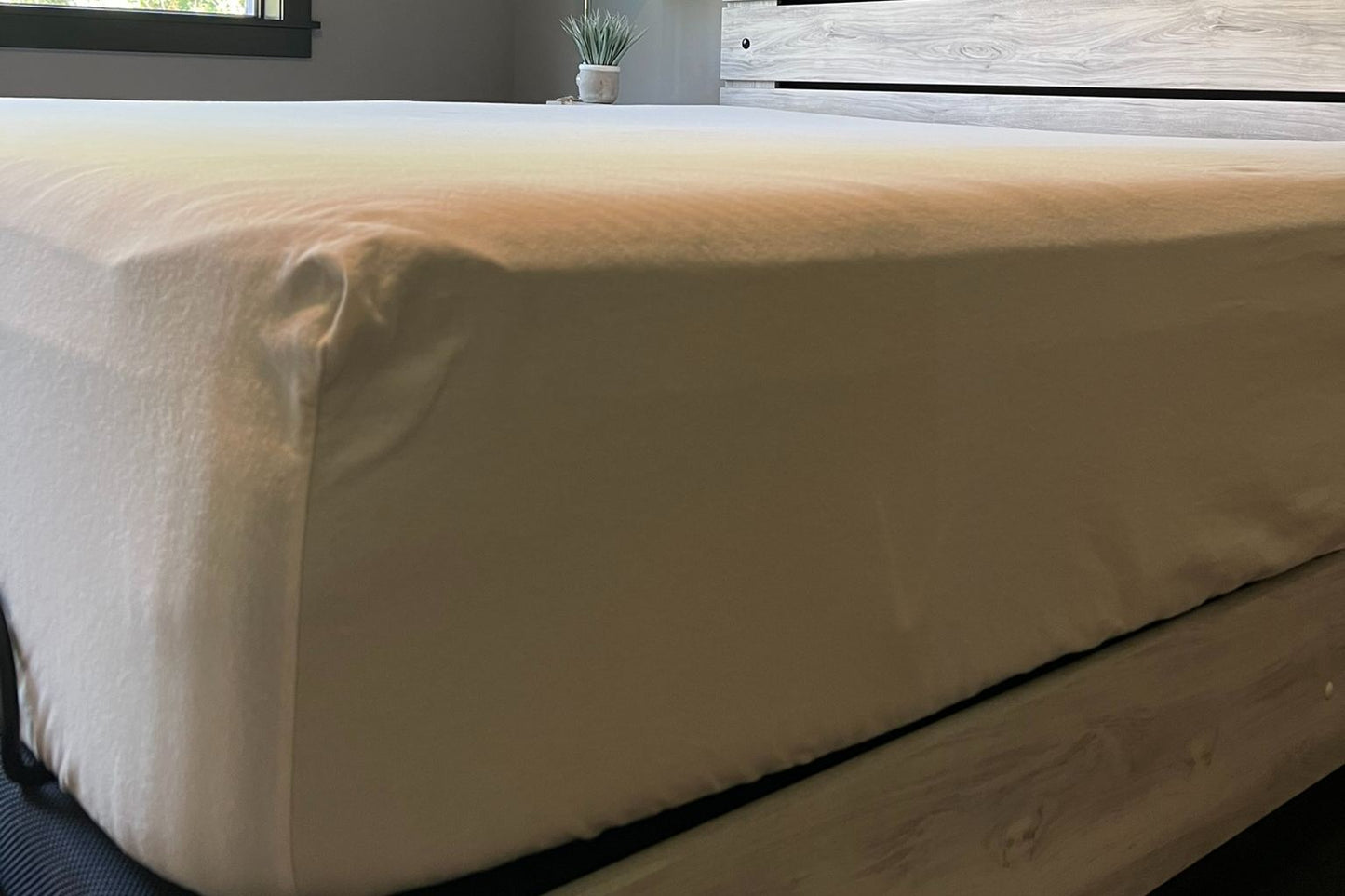 Mattress with a flannel fitted sheet on a bed in a room setting