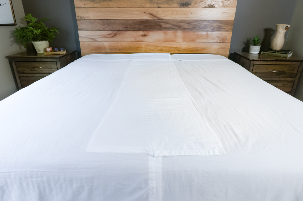 Flat sheet on bed featuring overlap in middle